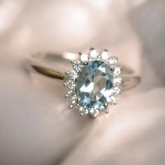 an oval cut blue topaz ring with diamond accents