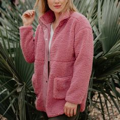 Introducing our Mauve Wholesale Oversized Sherpa Jacket for Women, a must-have addition to your boutique's fall collection! Crafted with premium sherpa fleece material, this jacket offers both style and comfort. The soft mauve color adds a touch of femininity to any outfit, while the oversized silhouette provides a relaxed and on-trend look. Perfect for layering over sweaters or tees, this jacket is versatile and effortlessly chic. Stock up now and give your customers the cozy and stylish outerwear option they've been searching for! 100% polyester machine wash cold, dry flat oversized look has 2 front pockets zipper closure optional snap closure Pink Fleece Jacket Outfit, Fall Solid Fleece Jacket With Fleece Lining, Solid Fleece Jacket For Fall, Oversized Fleece Outerwear For Fall, Soft Textured Outerwear For Fall, Cozy Fit Soft Texture Outerwear For Layering, Cozy Fit Outerwear With Soft Texture For Layering, Cozy Solid Color Outerwear With Fleece Lining, Cold Weather Sherpa Outerwear With Soft Texture