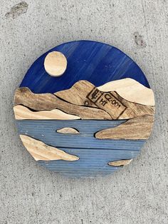 a small wooden plate with a painting on it