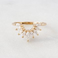 a gold ring with three pear shaped diamonds