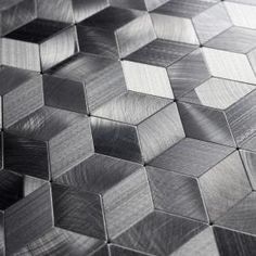 a close up view of a metal surface that looks like hexagonals or cubes