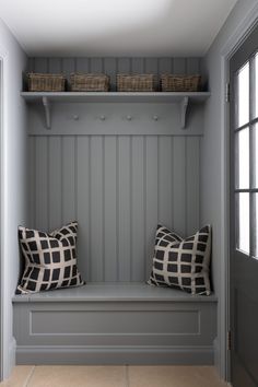 two pillows are sitting on a bench in the hallway