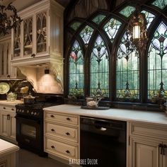 a kitchen with an oven, sink and large stained glass window in the back wall