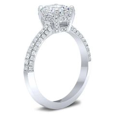 a diamond engagement ring with two rows of diamonds on the band and an oval shaped center stone