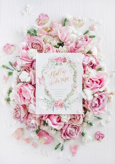 the wedding card is surrounded by pink roses and white peonies on a white background