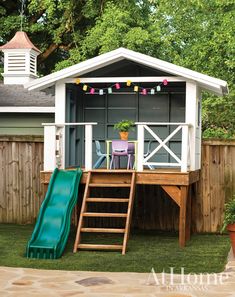 a small house with a slide in the yard