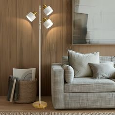 a living room scene with focus on the floor lamp and sofa in the foreground