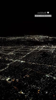 an aerial view of the city lights at night, taken from an airplane in the sky