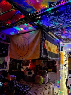 a room filled with lots of different colored lights and decorations on the ceiling above it