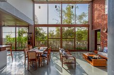 a large open living room with lots of windows and wooden furniture in it's center