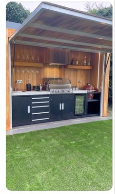 an outdoor bbq area with cabinets, stoves and grilling equipment in it