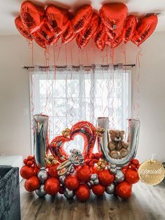 the balloons are in the shape of letters and hearts