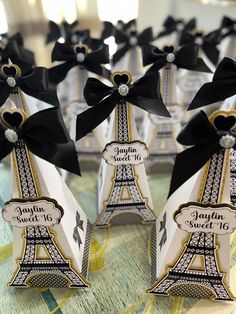 some sort of eiffel tower with black bows on it's head and name tags