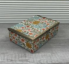 a decorative box sitting on top of a wooden table