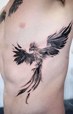 a black and white bird tattoo on the chest