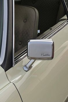 a car door handle with the word cadillac on it