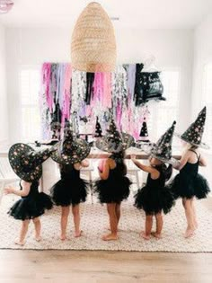 the girls are dressed up as witches in black tutu skirts and matching witch hats