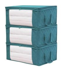 three storage bins stacked on top of each other, one with two white pillows