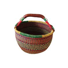 a pink and brown basket sitting on top of a white table next to a red handle