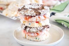 three powdered sugar cookies stacked on top of each other