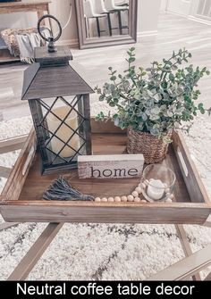 a tray with a candle and some plants on it that says neutral coffee table decor