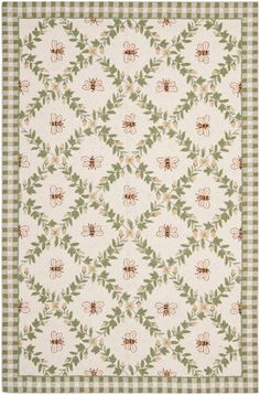 a white rug with green and brown flowers on the bottom, in front of a checkered background