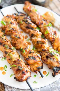 grilled chicken skewers on a white plate