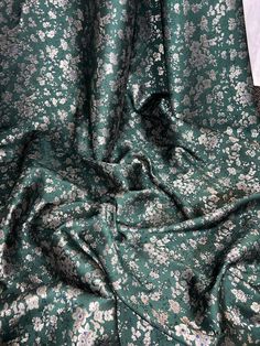 "BOTTLE GRREN FLORAL PRINT BROCADE FABRIC Product information 1 mtr bottle green floral print brocade fabric 58\"wide 147cm Brocade fabric are widely used for evening dresses,draperies and upholstery. Ideal for decorations,dress making,bridal,,dress lining,waistcoats,jackets,table runners,crafts, drapery,decorations and many other projects Sold by the mtr If more than one quantity is bought it will be sent as one continous length" Elegant Green Fabric For Festive Occasions, Elegant Green Festive Fabric, Brocade Dresses, Pretty Fabric, Brocade Fabric, Beautiful Fabric, Dress Making, Upholstery Fabric, Bridal Dresses