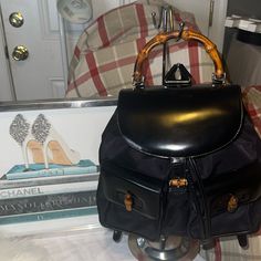 Vintage 90s Gucci Nylon And Patent Leather Backpack From The Princess Diana Days. Roomy, Chic And Durable. Real Bamboo Handle Is Smooth And Natural. C O N D I T I O N Excellent Pre-Loved Condition. At First Glance The Backpack Is Truly Flawless. Some Visible Marks/Wear On The Patent Leather And Bottom Piping. This Bag Is Older Than 20 Years And Come With All Of Its Original Hardware. M E A S U R E M E N T S In Inches: Length: 13" Height: 10" Strap Handle Drop (Bamboo): 3.5" Depth: 3.5" Classic Gucci Backpack For Travel, Gucci Backpack For Everyday Use, Gucci Luxury Backpack For Everyday, Casual Gucci Travel Bag, Luxury Everyday Gucci Backpack, Gucci Luxury Everyday Backpack, Gucci Black Backpack For Everyday Use, Gucci Backpack With Dust Bag For Travel, Classic Gucci Travel Backpack