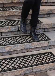 a person standing on some steps wearing black shoes