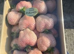 a box filled with lots of pink strawberries