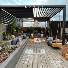 an outdoor living area with couches, tables and potted plants on the deck