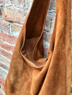 Slouch bag in soft brown suede. Soft leather shopper. LARGE tote leather bag in CAMEL BROWN with zipper. Natural genuine SUEDE leather. NOT LINED. Light tobacco color carry all bag. Width : 42cm - 16,5 in Height at the center: 34 cm - 13, 5 inc Total height : 65,5 cm - 26 inch This bag in different colors and other leather Bags by Good Times Barcelona: https://www.etsy.com/shop/goodtimesbarcelona?section_id=18820154&ref=shopsection_leftnav_10 Also available a matching camel brown suede bel a Suede Hobo Shoulder Bag With Zipper, Suede Hobo Shoulder Bag With Zipper Closure, Suede Hobo Bag With Zipper Closure, Brown Leather Hobo Bag With Suede Lining, Brown Hobo Bag With Suede Lining For Shopping, Suede Hobo Bag With Large Capacity For Travel, Cognac Suede Bag For Daily Use, Rectangular Brown Hobo Bag With Suede Lining, Suede Bags With Leather Lining For Shopping