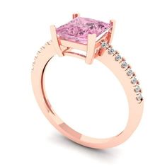 a pink diamond ring with diamonds around it