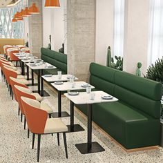 an empty restaurant with green booths and white tables