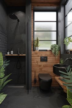 a bathroom with black walls and wooden flooring next to a plant filled shower stall