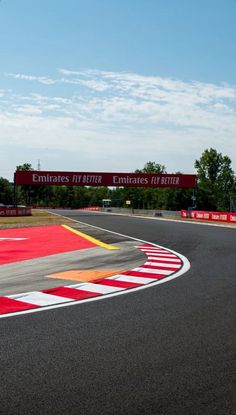 a red and white race track with a sign in the background that says emirates emirates emirates