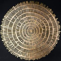 a circular basket made out of bamboo sticks