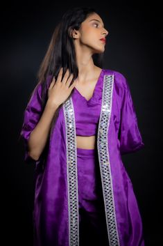 Achieving a perfect balance between traditional craft, contemporary silhouette, and sustainability, this breezy purple co-ord set made from vegan uppada silk is a stunning example of craftsmanship. Embellished with glistening mirror work and a zari border, this look is an impeccable fusion of style, elegance, and sustainability.Details Neckline: V Neck Material: Uppada silk Lining: Cotton-polyester Made in India What makes this outfit sustainable?Uppada silk, made from a viscose blend, is a sust Elegant Purple Sets For Diwali, Festive Purple Palazzo Set For Party, Elegant Lavender Sets For Festive Occasions, Elegant Lavender Festive Sets, Elegant Festive Lavender Sets, Purple Silk Sets For Diwali, Silk Purple Sets For Diwali, Bollywood Style Purple Palazzo Set For Party, Purple Sets For Diwali Celebration