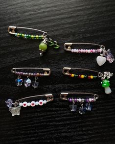 six different colored hair clips sitting on top of a wooden table