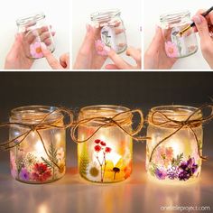 three jars with flowers painted on them, one is filled with water and the other has a pen in it