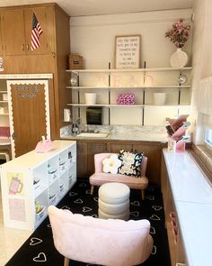 a doll house with furniture and accessories in it's living room, including a pink chair