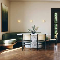 a dining room table with two chairs and a bench