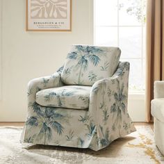 a blue and white chair sitting in front of a window