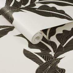 a white and black wallpaper with leaves on it