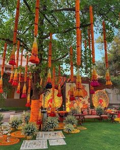 an outdoor area with lots of decorations on the grass and trees in front of it