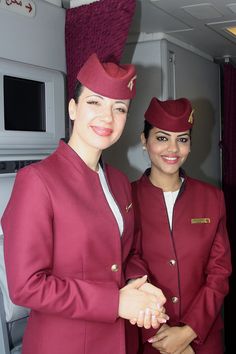 two women in red uniforms standing next to each other