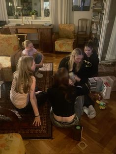 several people sitting on the floor in a living room