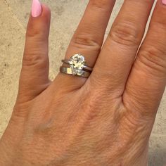 a woman's hand with two rings on it