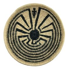 a black and white basket with an intricate design in the center, on a white background